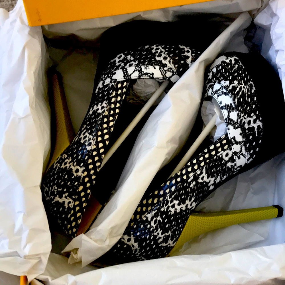 Fendi snake skin print peep toe pumps.
